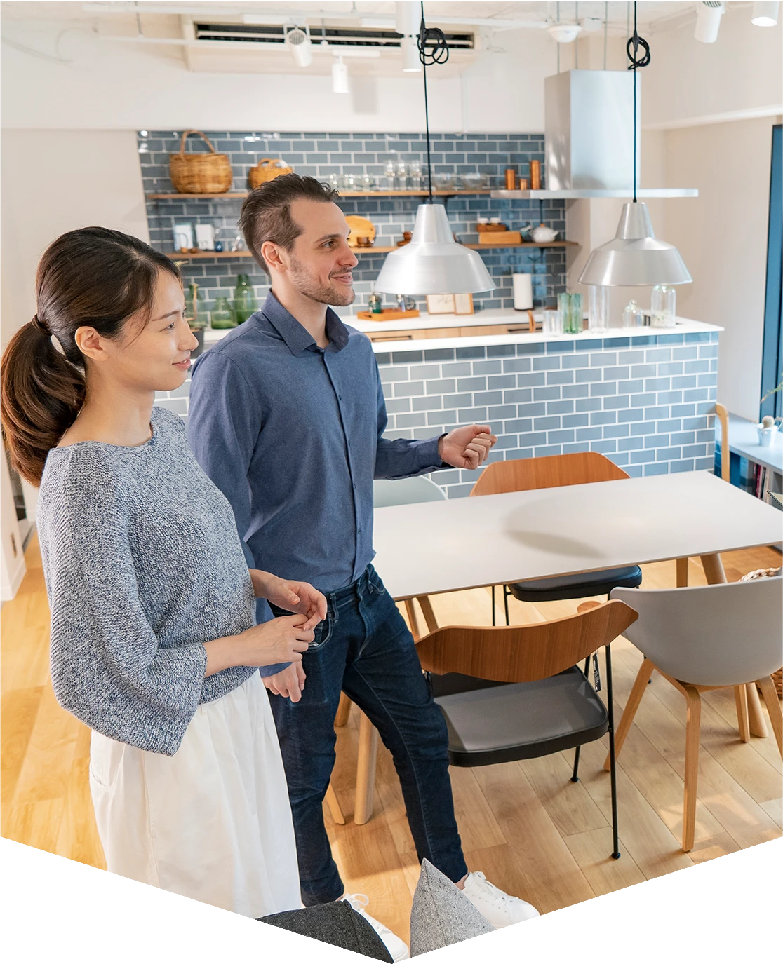 Couple walking in modern kitchen area.