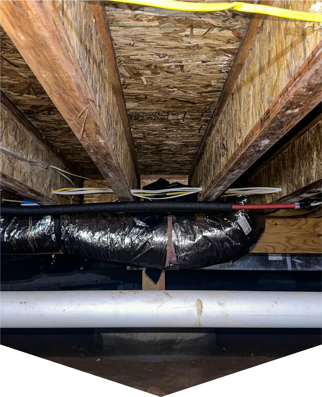 Basement ceiling with insulation and ducts.