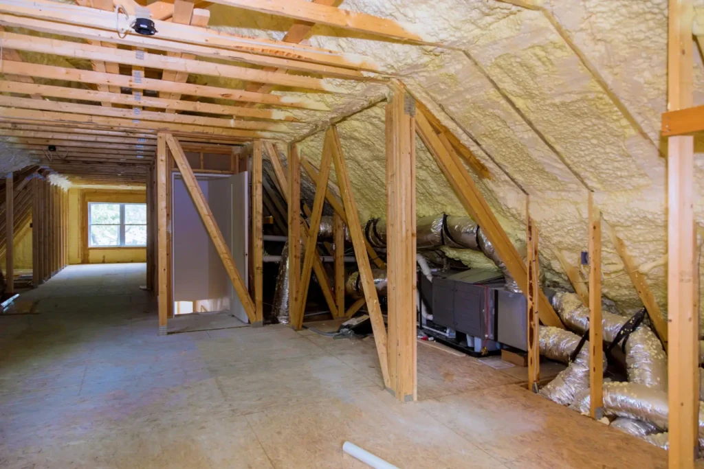 Unfinished attic with insulation and ductwork.